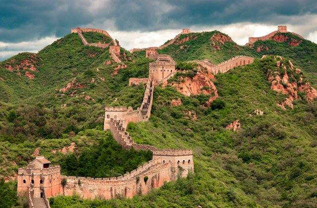The Great Wall winding over green mountains