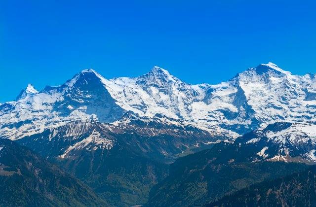 Snow-covered Alps under blue sky
