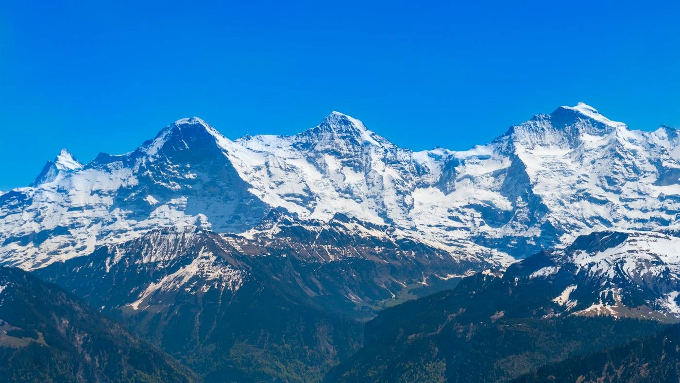 Snow-covered Alps under blue sky